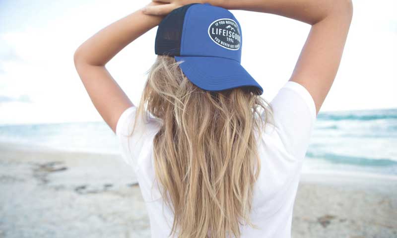 Model with Hat on Beach. Photo Provided by Life is Good