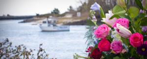 Motor boat in background of wedding flowers, Photo Credit: Focus Photography