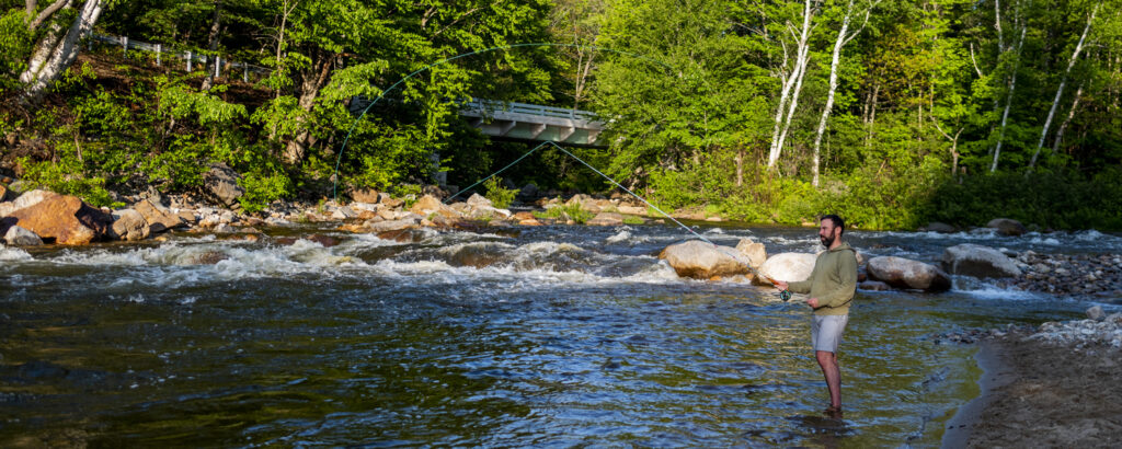 Man fishing across river, Photo credit to Capshore Photography