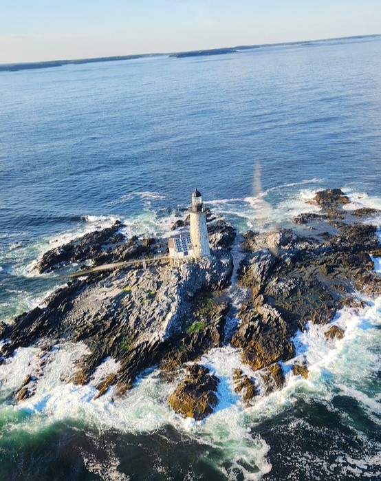 Flying over Lighthouse. Photo Credit: Pine Tree Helicopters