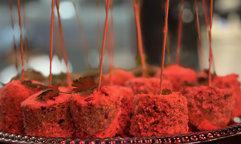 Food closeup under red light; Photo Credit: Lauren Peters at Visit Portland